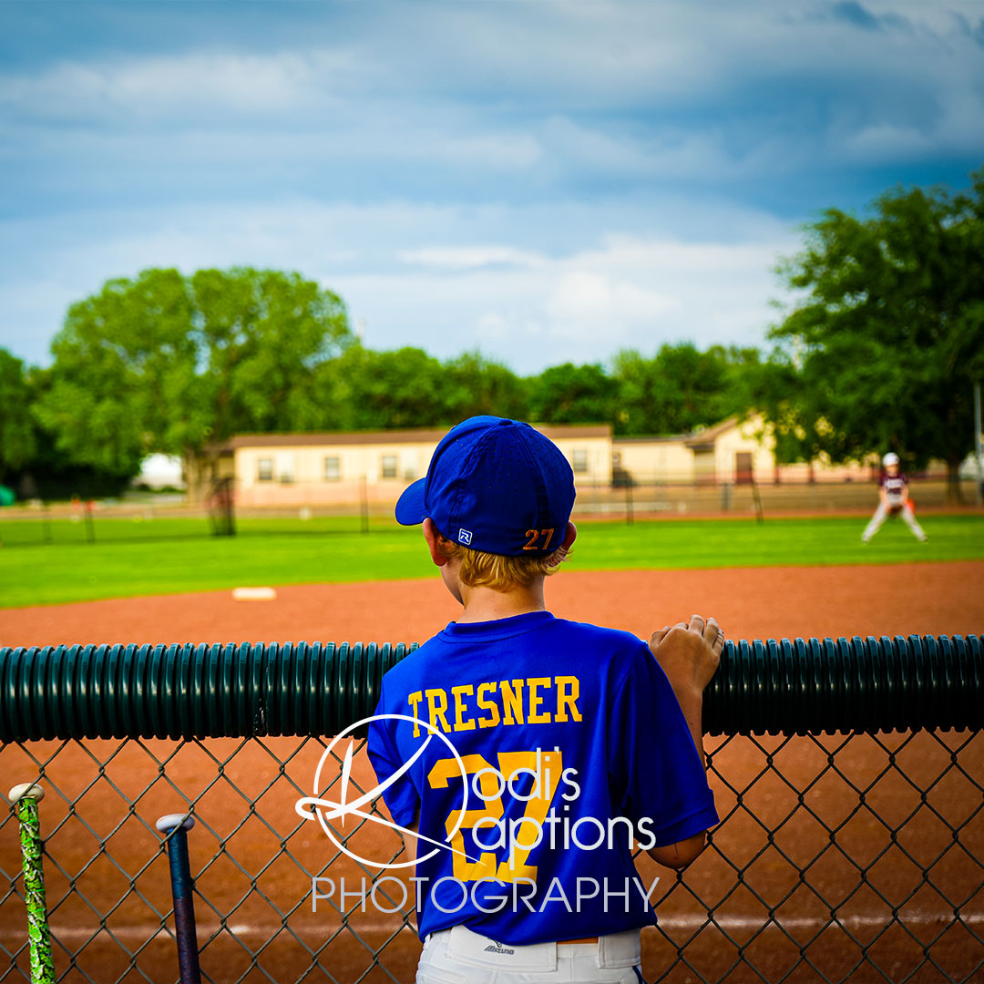 child photographed at softball game