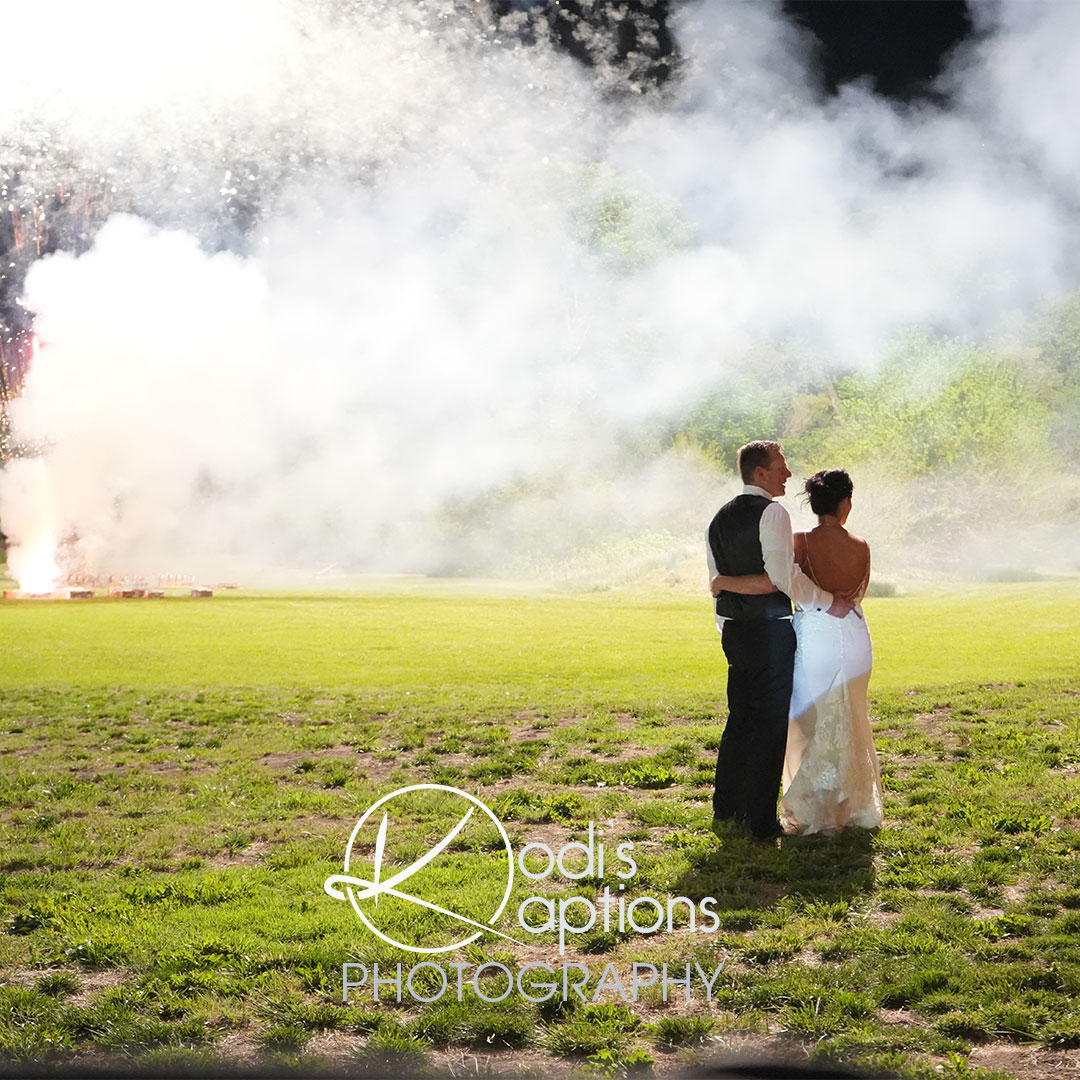 wedding couple in an open field during a firework 
